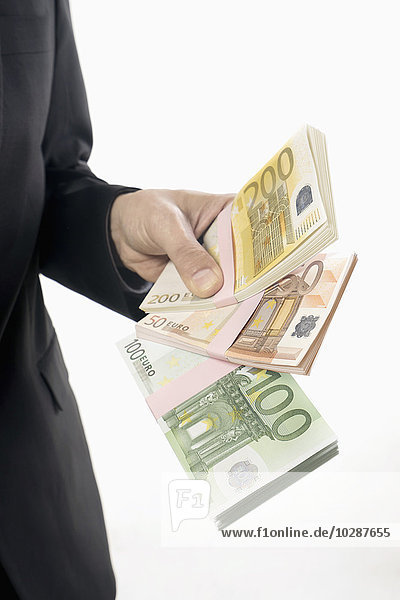 Businessman holding Euro banknotes  Bavaria  Germany