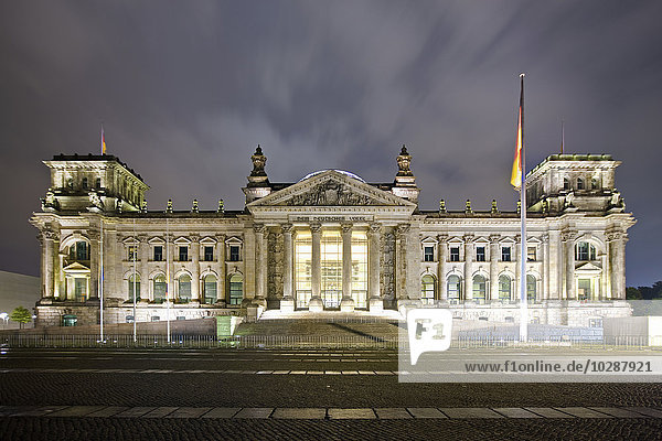 Facade of a government building lit up at dusk  The Reichstag  Berlin  Germany