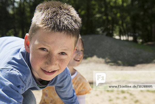 Junge und Mädchen spielen auf einem Spielplatz  München  Bayern  Deutschland