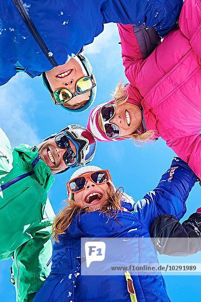Low angle view of family in winter clothing and sunglasses