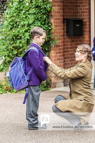 Mother getting son ready for school