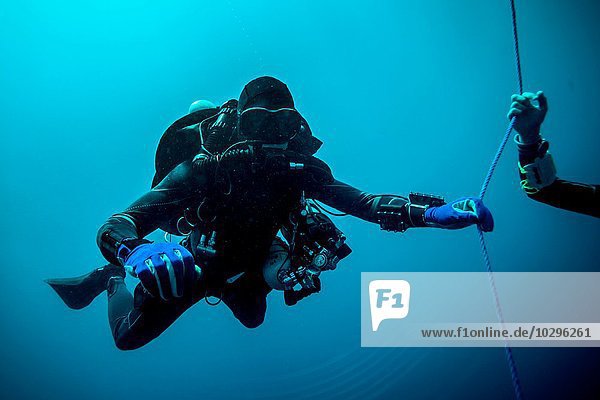 Underwater view of technical diver using a rebreather device to locate shipwreck  Lombok  Indonesia