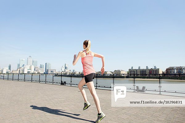 Runner jogging along waterfront  Wapping  London