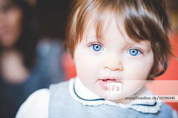 Close up portrait of female toddler with blue eyes