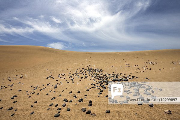 Dunes  sand dunes of Maspalomas  cloud formation  black stones in the sand  nature reserve  Gran Canaria  Canary Islands  Spain  Europe