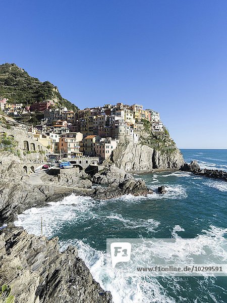 Rocky coast and view to the village of Manarola  Cinque Terre  Manarola  Liguria  Italy  Europe