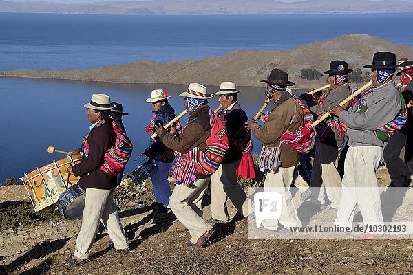 Music Chapel with Indios  procession in traditional dress for the winter solstice  New Year festival T`aqa  Aymara Indians  Sun Island  Isla del Sol  Lake Titicaca  Bolivia  South America