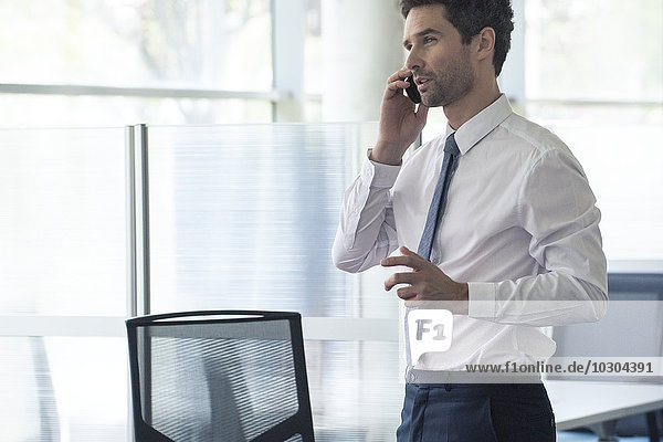 Businessman at office using cell phone
