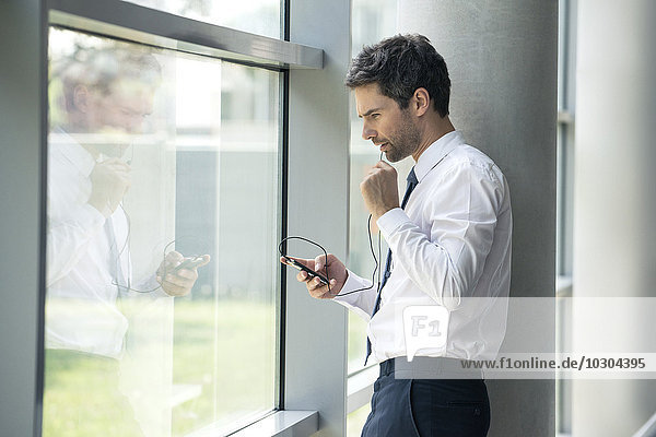Man using cell phone with hands-free device