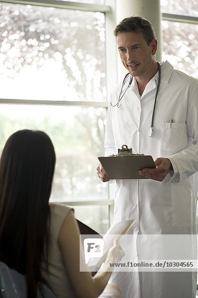 Doctor greeting patient in waiting room