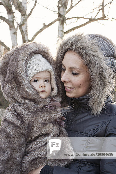 Mother and baby girl dressed in winter coats  portrait