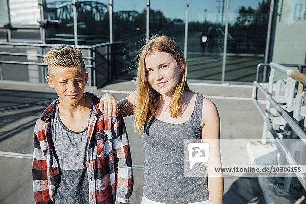 Portrait of two teenagers on pedestrian bridge