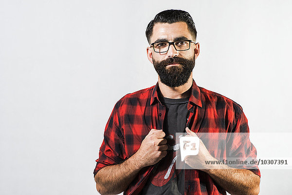 Portrait of hipster in front of light background