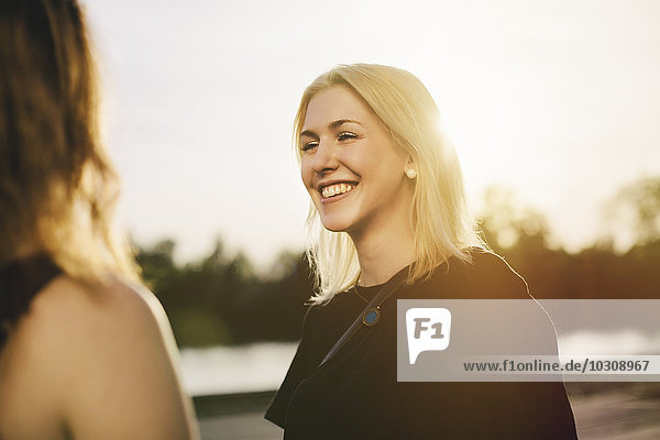 Smiling blond woman looking at her friend