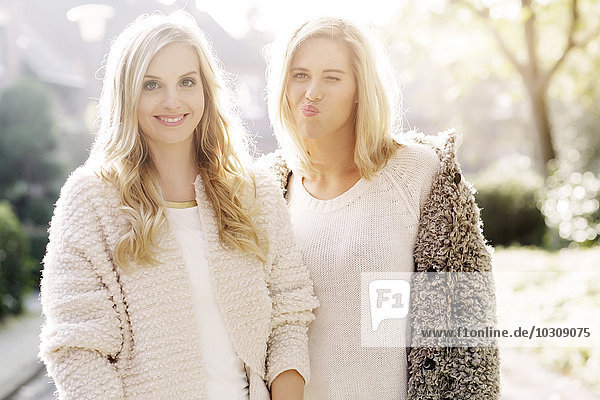 Portrait of two blond women at backlight