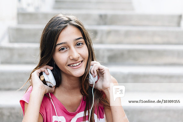 Portrait of smiling teenage girl with headphones