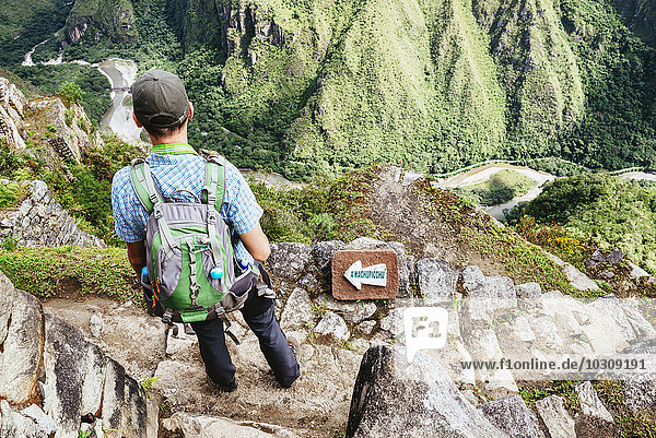 Peru  Machu Picchu region  traveler lokking at Machu Picchu citadel
