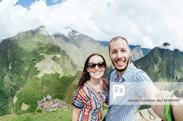 Peru  Machu Picchu region  Travelling couple taking selfie