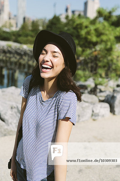 USA  New York City  portrait of laughing young woman wearing black hat