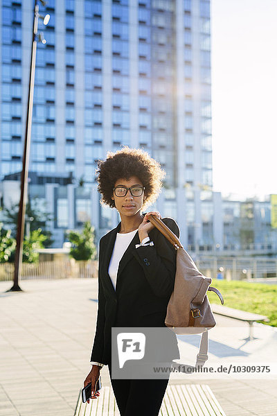 USA  New York City  portrait of businesswoman with bag