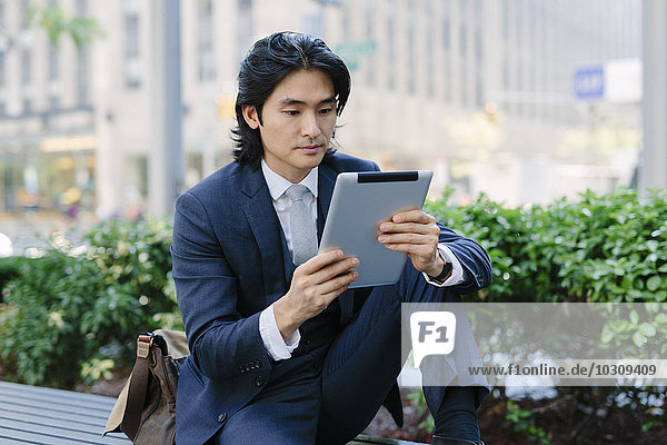 USA  New York City  Manhattan  businessman looking at digital tablet
