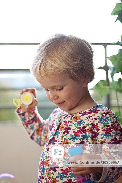 Portrait of little girl with bubble ring