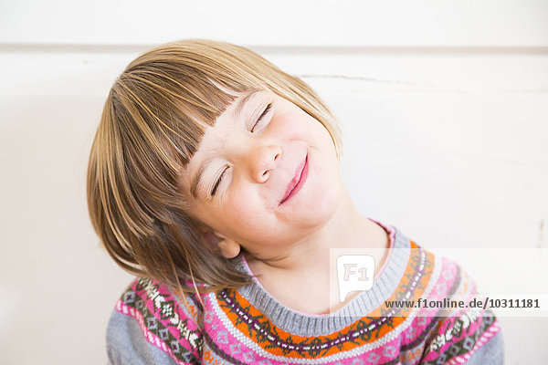 Portrait of cute little girl with closed eyes
