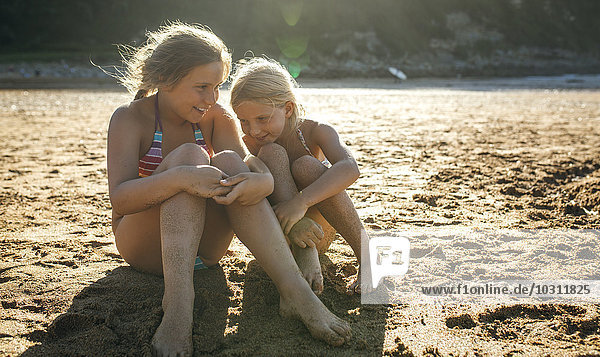 Zwei Schwestern beim gemeinsamen Spaß am Strand