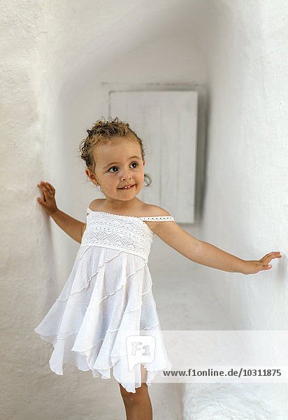 Spain  Balearic Islands  Menorca  Binibeca  portrait of little girl wearing white summer dress