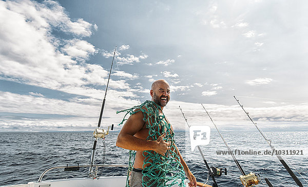 Spain  Asturias  Fisherman on fishing boat on Cantabrian Sea