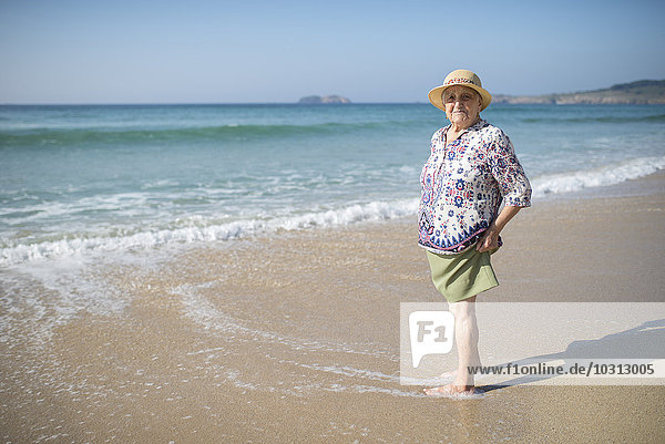 Spain  Ferrol  portrait of senior woman standing on the beach