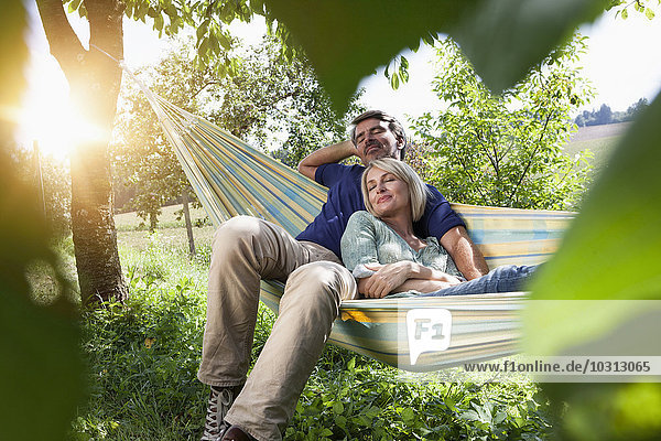 Relaxed mature couple in hammock
