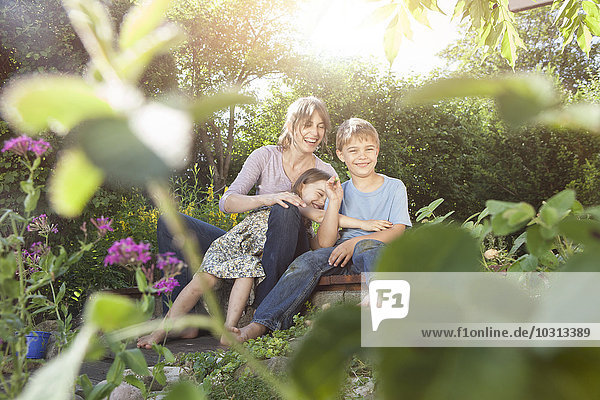 Happy mother  son and daughter in garden