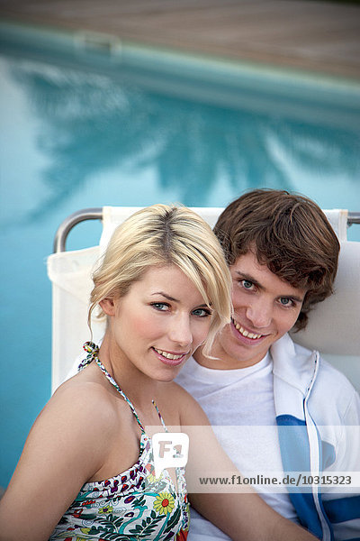 Portrait of smiling couple at the poolside