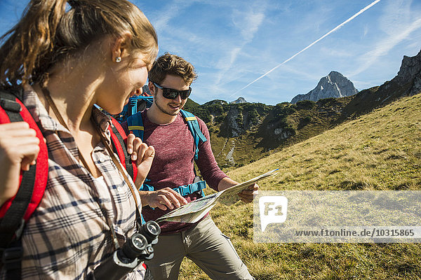 Austria  Tyrol  Tannheimer Tal  young hikers looking at map