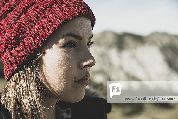 Austria  Tyrol  Tannheimer Tal  young woman wearing red wooly hat