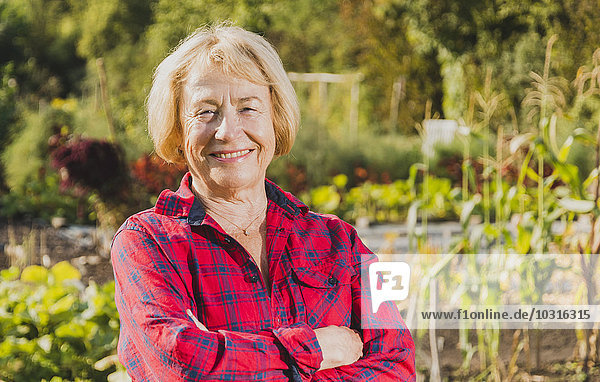 Portrait of smiling senior woman in garden