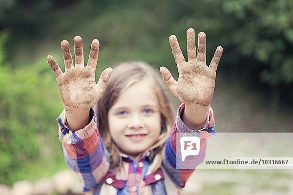 Kleines Mädchen mit schmutzigen Händen