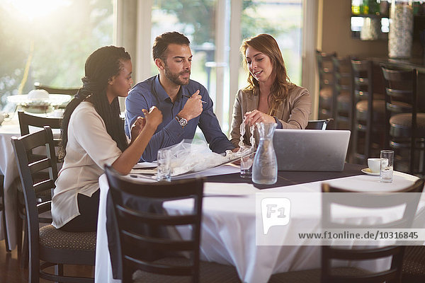 Business meeting of three people in a restaurant