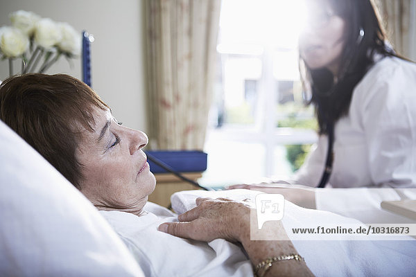 Senior woman lying in hospital bed