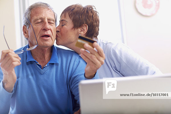 Senior couple shopping online at home