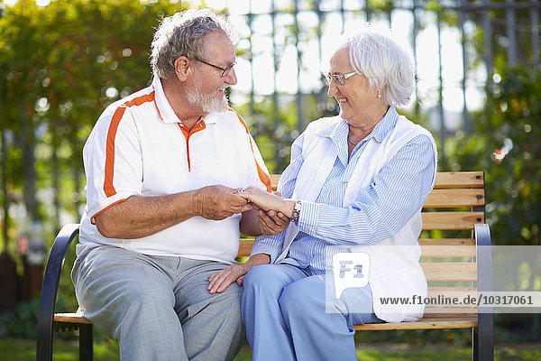 Happy senior couple on park bench