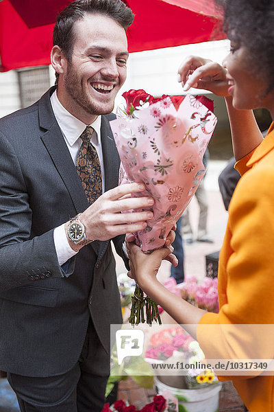 Man buying red roses for a woman