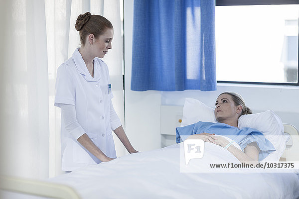 Krankenschwester hilft Patientin im Krankenhaus