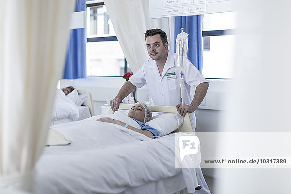 Nurses moving patient lying in bed