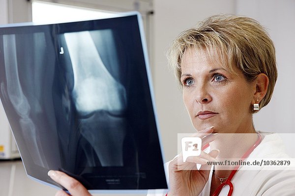 Female Doctor in a hospital looking at an x-ray image