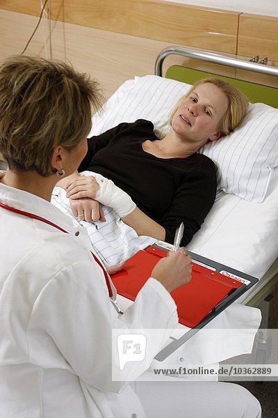 Female doctor in a hospital talks to a patient