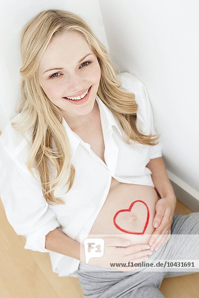 MODEL RELEASED. Happy pregnant woman. She is seven months pregnant.