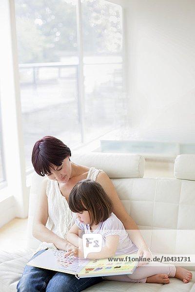 MODEL RELEASED. Mother and daughter reading.