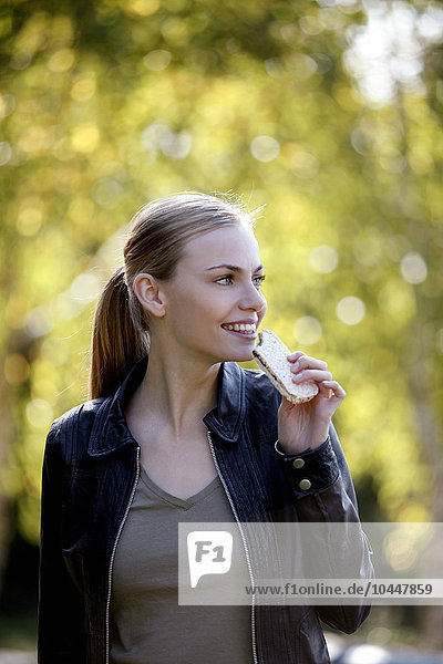 Mädchen isst einen Snack im Park